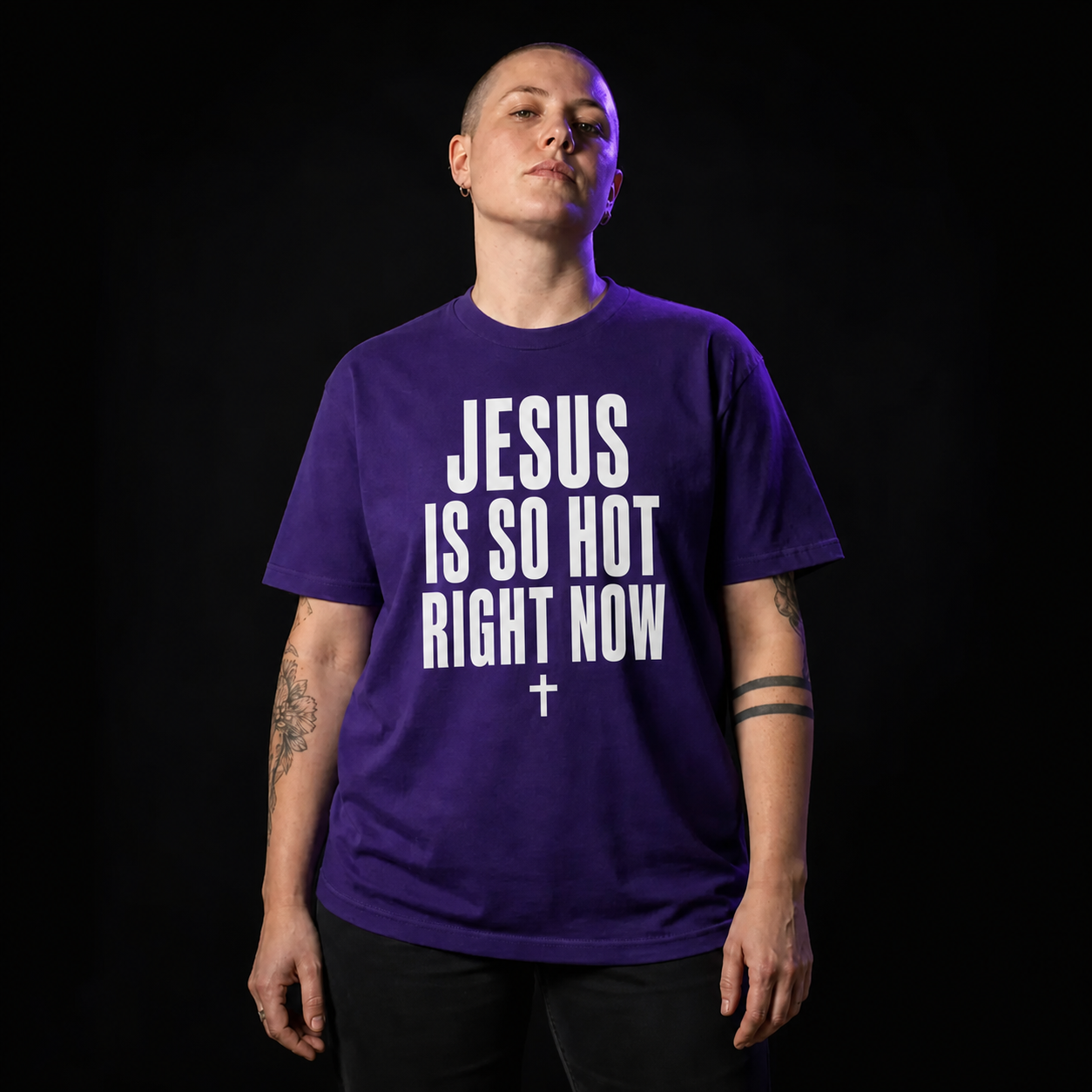Model wearing the purple JESUS IS SO HOT RIGHT NOW tee